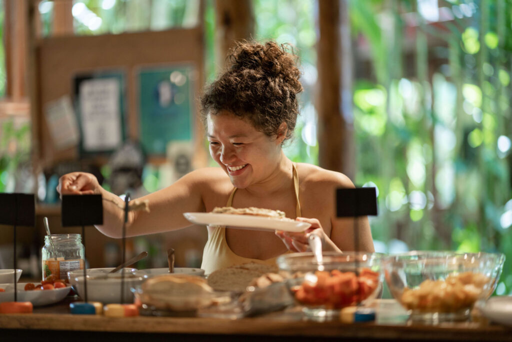 A female bodhi surf + yoga guest enjoying the food.