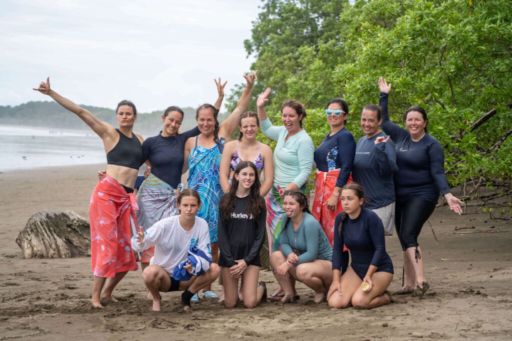 A group of women standing on the beach at Uvita. 