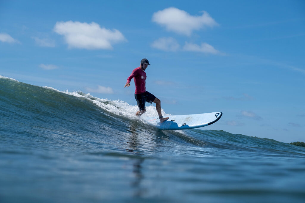 longboard surfboard catching a wave